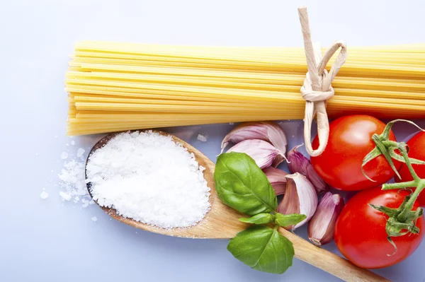 Spaghetti and tomatoes with herbs on an old and vintage wooden t — Stock Photo, Image