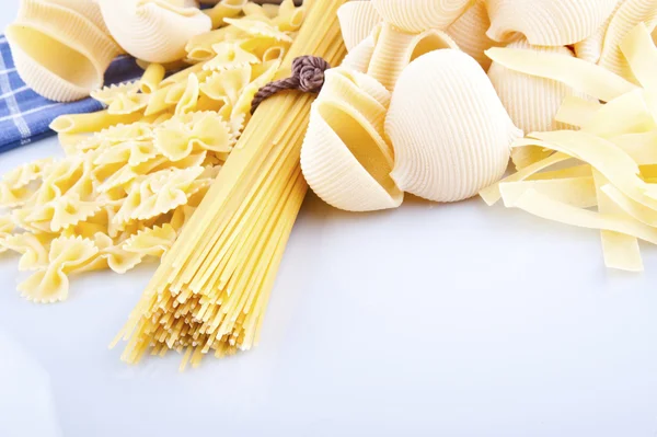 Italian pasta, eggs and rolling pin on a white background — Stock Photo, Image