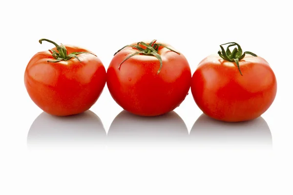 Three tomatoes. White background. — Stock Photo, Image