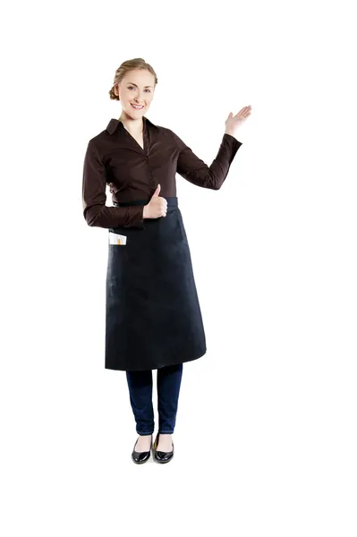 Waitress pointing. Woman in apron smiling happy isolated on whit — Stock Photo, Image