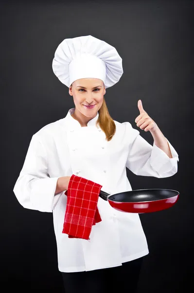 Jeune femme chef avec différents outils sur blanc — Photo