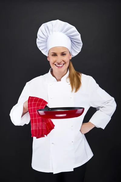 Jeune femme chef avec des outils sur fond sombre — Photo