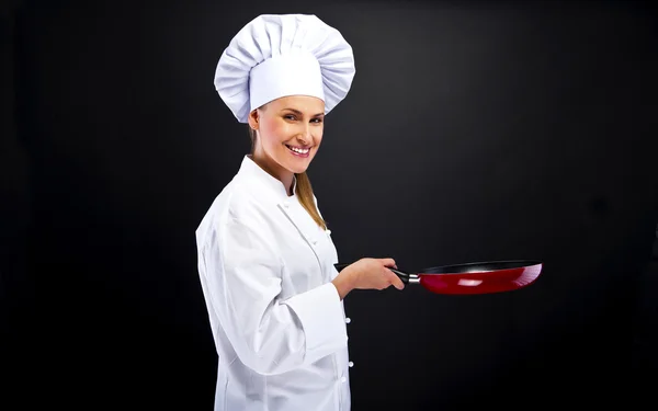 Jonge vrouw chef-kok met verschillende hulpmiddelen op wit — Stockfoto