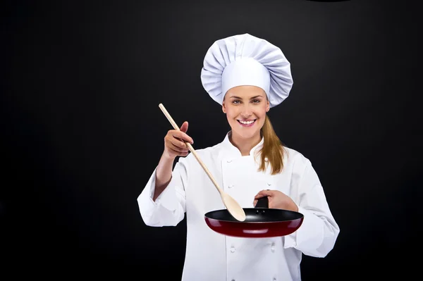 Beautiful blonde woman housewife holding pan on white dark backg — Stock Photo, Image