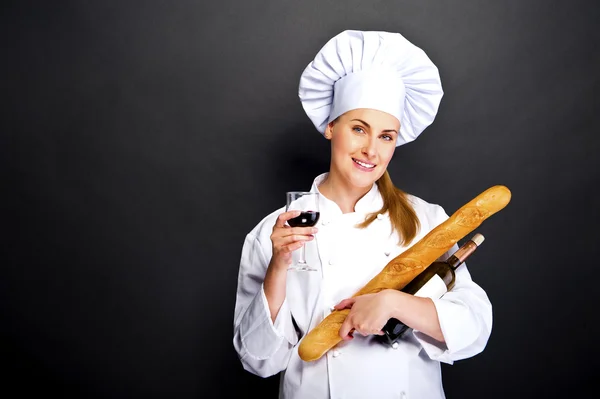 Woman chef with french bread and wine glass — Stock Photo, Image