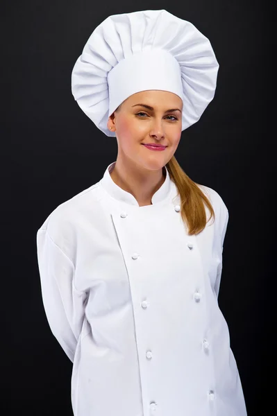 Vrouw chef-kok over de donkere achtergrond — Stockfoto