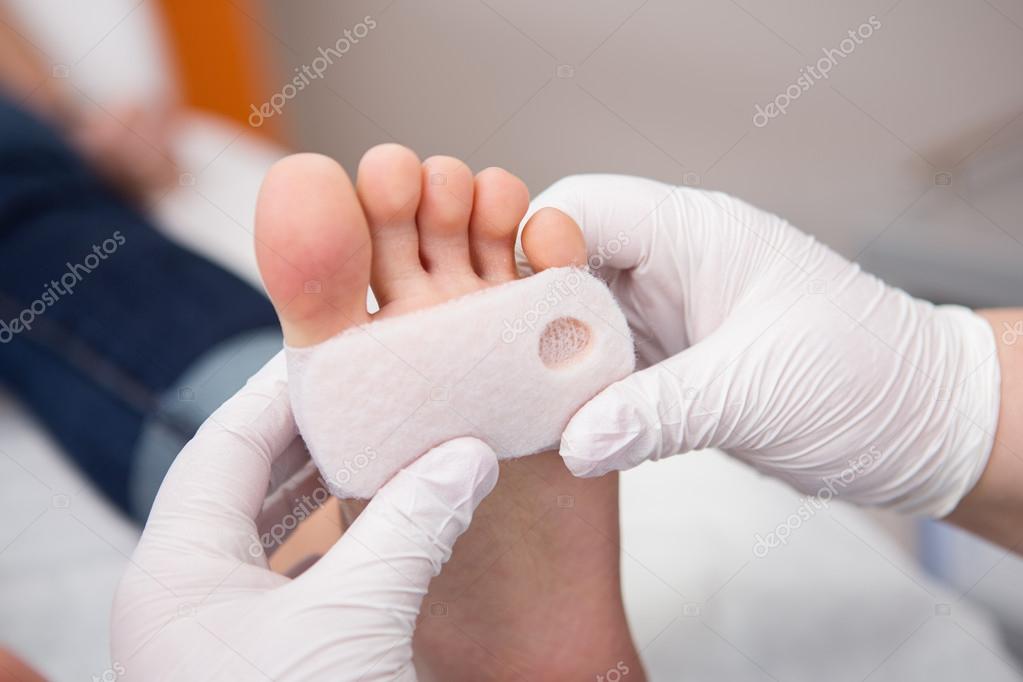 podiatrist ( chiropodist ) cleaning womans feet