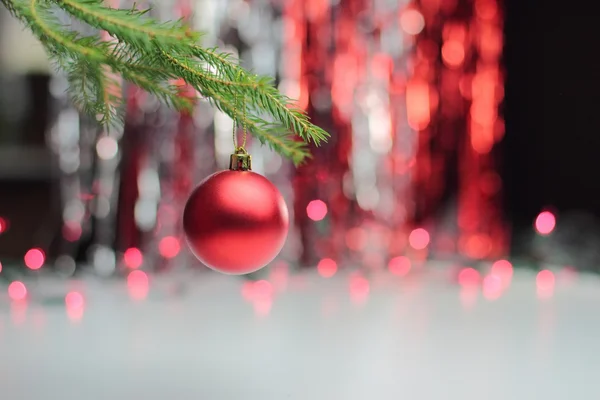 Red christmas ball hanging on branch — Stock Photo, Image