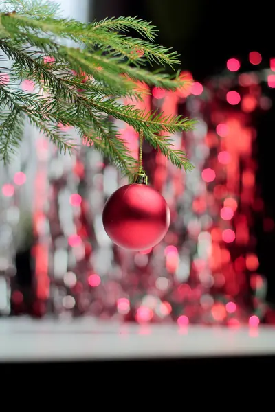 Red christmas ball hanging on branch — Stock Photo, Image