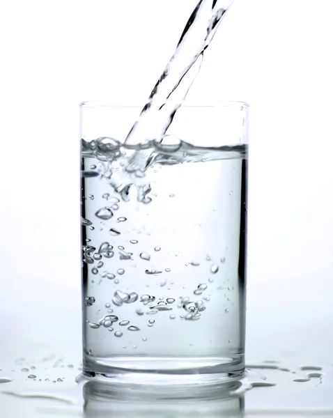 Pouring fresh water on the glass — Stock Photo, Image