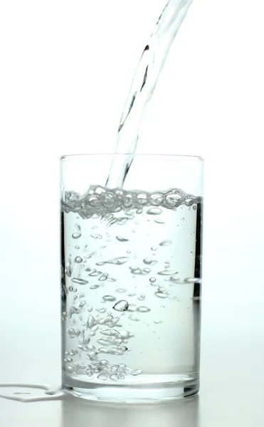 Pouring fresh water on the glass — Stock Photo, Image