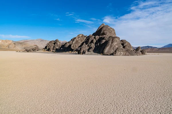 Rock island on the dry lake bed of the Racetrack Playa in Death Valley National Park