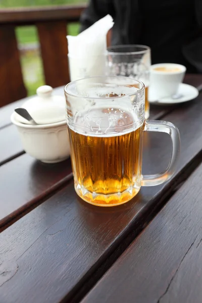 Beer mug on a table in a city restaurant outdoor — Stock Photo, Image
