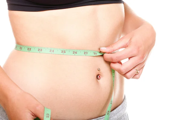 Woman slim stomach with measuring tape around it Stock Photo