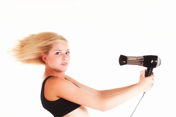 Genç kadın üzerinde beyaz izole saç kurutma — Stok fotoğraf