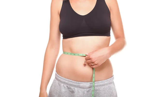 Woman slim stomach with measuring tape around it — Stock Photo, Image