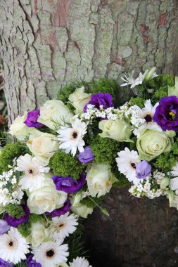 Detail of a Sympathy wreath in white and purple clipart