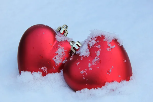 Two red hearts in the snow — Stock Photo, Image