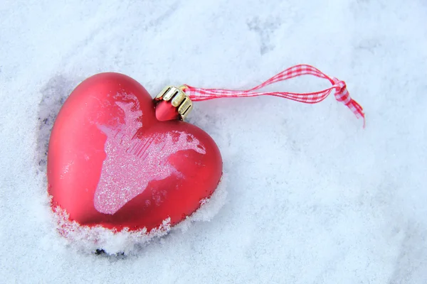 Heart shaped ornament in the snow Stock Picture