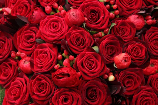 Ranunculus, berries and roses in a group Stock Picture