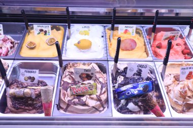 Barcelona, Spain - september 30th 2019: Various ice cream flavors at La Boqueria Market. Scoopable flavors with fruit. Text on labels: ingredients in Spanish