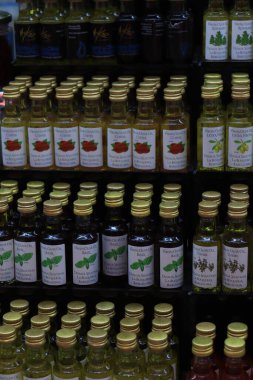 Barselona, İspanya - 30 Eylül 2019: La Boqueria Market 'te zeytinyağı. Bir şişe zeytinyağı, portakal, fesleğen, kahve..