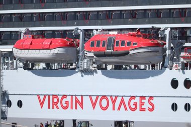 IJmuiden, The Netherlands - April 20th, 2022:  Valiant Lady cruise ship, operated by Virgin Voyages,detail of red lifeboats