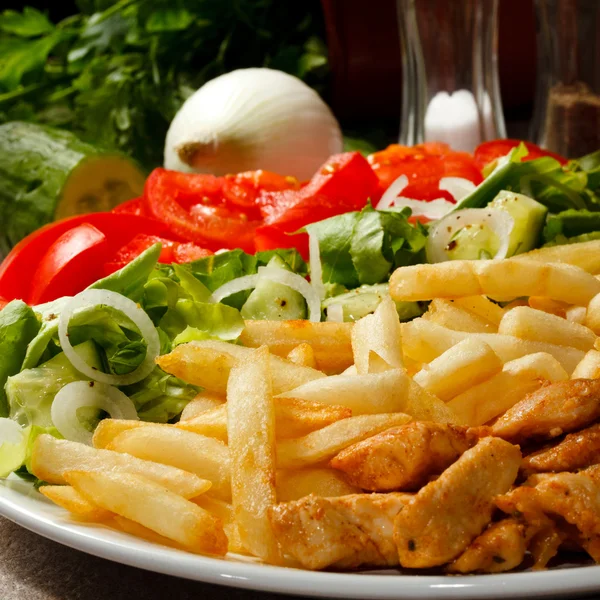 Grilled meat French fries and vegetables on white background — Stock Photo, Image