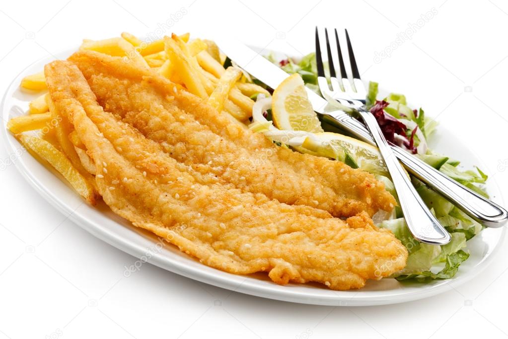 Fish dish fried fish fillet, French fries with vegetables Stock Photo