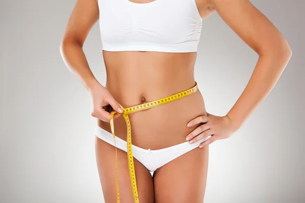Woman measuring her slim body — Stock Photo, Image