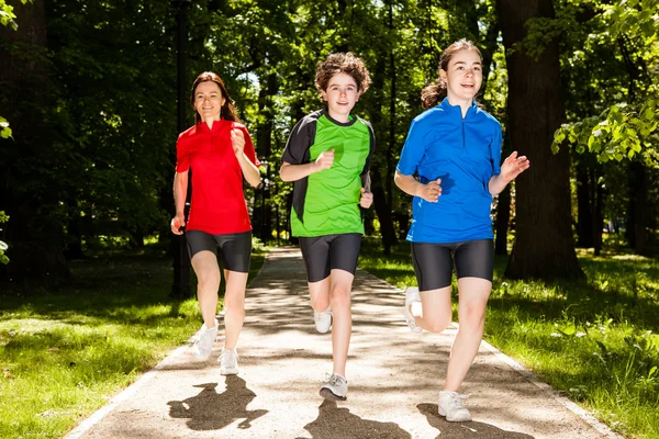 Active family - mother and kids running outdoor — Stock Photo, Image