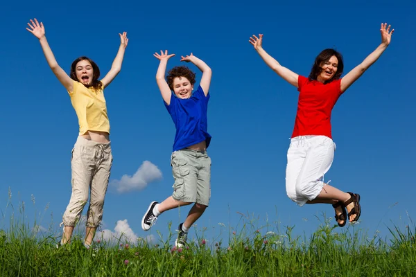 Active family - mother and kids running, jumping outdoor — Stock Photo, Image