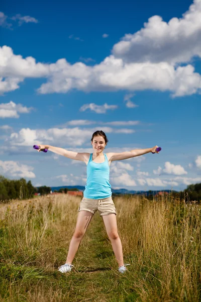 Young girl exercising outdoor — Stock Photo, Image