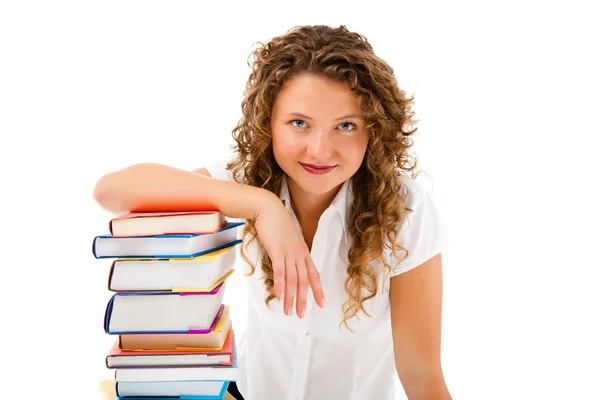 Mujer joven detrás de un montón de libros aislados sobre fondo blanco — Foto de Stock