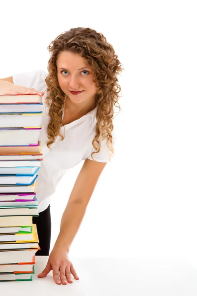 Mujer joven detrás de un montón de libros aislados sobre fondo blanco — Foto de Stock