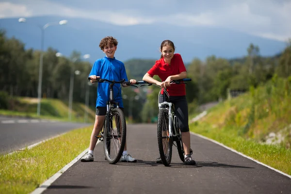 Ragazza e ragazzo in bicicletta — Foto Stock