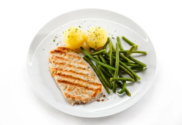 Grilled steaks, baked potatoes and vegetables — Stock Photo, Image