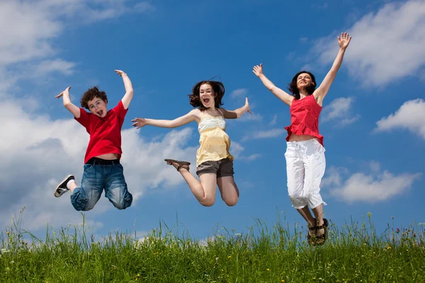 Active family - mother and kids running, jumping outdoor Stock Image