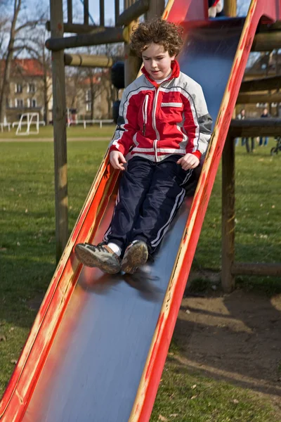 Kid on slide — Stock Photo, Image