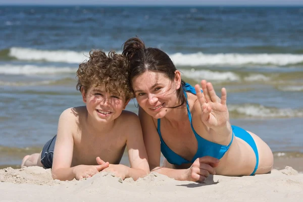 Mum with son on the beach Stock Photo