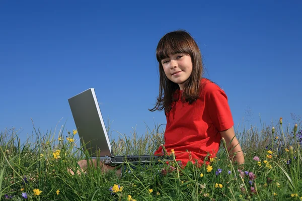 Girl with laptop on green meadow — Stock Photo, Image