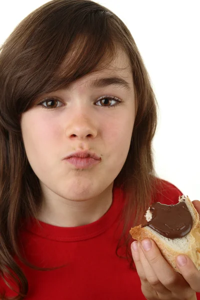 Girl eating bread with nut butter — Stock Photo, Image