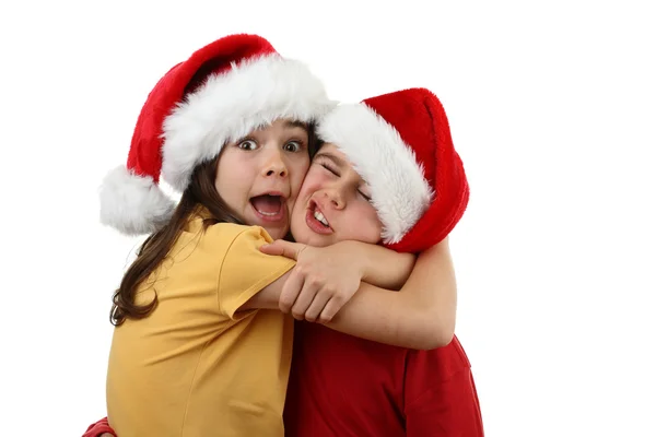 Menino e menina em chapéus de Papai Noel — Fotografia de Stock