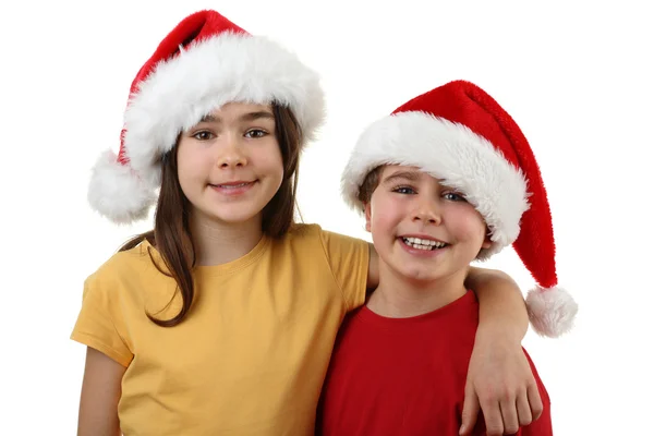 Menino e menina em chapéus de Papai Noel — Fotografia de Stock