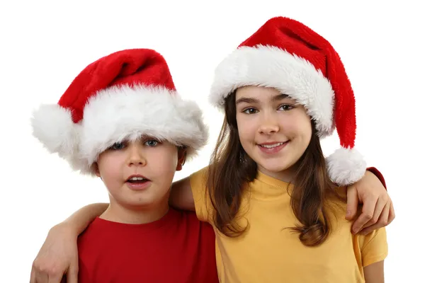 Garçon et fille dans les chapeaux du Père Noël — Photo