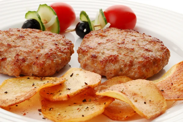 Fried steaks with chips and vegetables — Stock Photo, Image