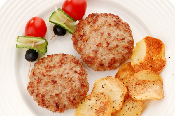 Fried steaks with chips and vegetables — Stock Photo, Image