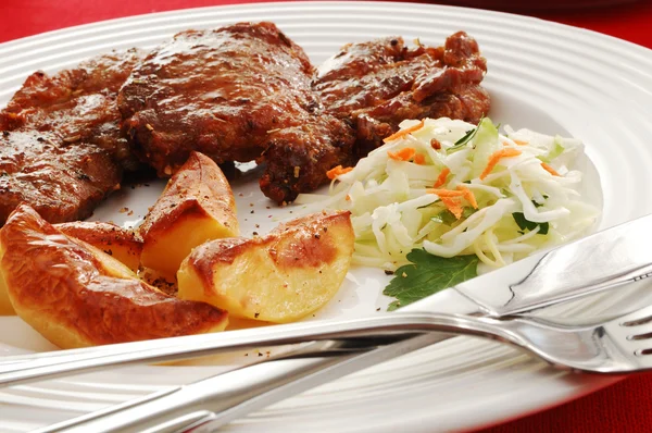 Fried steaks with chips and vegetable salad — Stock Photo, Image