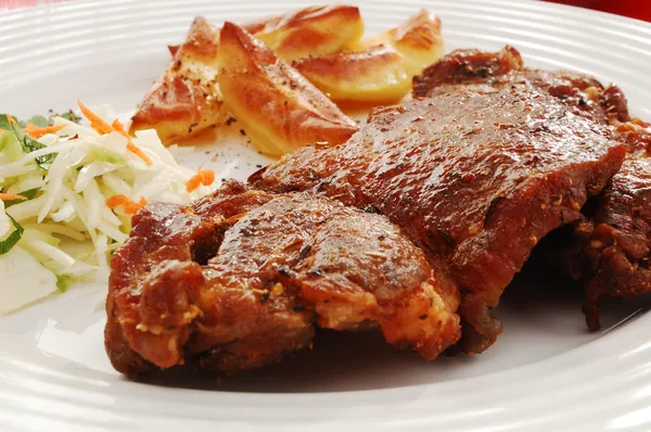 Fried steaks with chips and vegetable salad — Stock Photo, Image