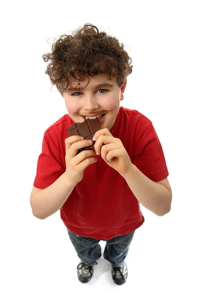 Menino comendo chocolate — Fotografia de Stock